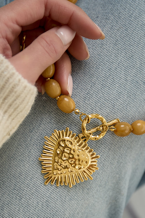Bead necklace with front closure charm